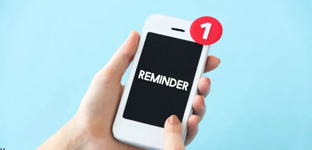 A smartphone screen displaying a ride reminder notification with a red alert badge.